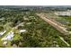 Panoramic aerial view showcases a luxury house nestled among lush trees in a tranquil setting, blending luxury and nature at 601 Suffolk Cir, Nokomis, FL 34275