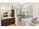 Spa bathroom with a double vanity, glass enclosed shower, and soaking tub with modern finishes at 601 Suffolk Cir, Nokomis, FL 34275