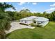 Beautiful home exterior with lush landscaping, and a metal roof providing curb appeal at 601 Suffolk Cir, Nokomis, FL 34275