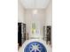 Elegant foyer with soaring ceilings, modern chandelier, tile floors, and decorative furnishings for a grand entrance at 601 Suffolk Cir, Nokomis, FL 34275