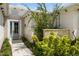 Charming front entrance with decorative stone accents, a gray front door, and professional landscaping at 601 Suffolk Cir, Nokomis, FL 34275