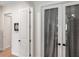 Hallway showing multiple doors in the home's interior, along with the hardwood flooring at 601 Suffolk Cir, Nokomis, FL 34275