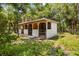 Exterior view of a horse stall featuring three stalls with gated entrances in a grassy outdoors landscape at 601 Suffolk Cir, Nokomis, FL 34275