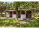 Picture of a horse stall with gated entrances set in an outdoors landscape at 601 Suffolk Cir, Nokomis, FL 34275