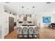 Modern kitchen with stainless steel appliances, large island with seating, and elegant finishes for cooking and entertaining at 601 Suffolk Cir, Nokomis, FL 34275