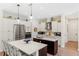Modern kitchen with stainless steel appliances, stylish cabinets, and an island with chairs at 601 Suffolk Cir, Nokomis, FL 34275