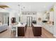 Bright, open kitchen featuring stainless steel appliances, double islands and wood flooring at 601 Suffolk Cir, Nokomis, FL 34275