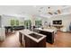 Open-concept living area with kitchen island, piano, black leather sofa and outdoor views at 601 Suffolk Cir, Nokomis, FL 34275