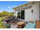 Comfortable outdoor patio with seating area, awning, and sliding glass doors for indoor-outdoor living at 601 Suffolk Cir, Nokomis, FL 34275