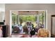Screened patio with outdoor seating, grill, fire pit and view of backyard landscaping at 601 Suffolk Cir, Nokomis, FL 34275