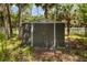 View of a secure backyard shed for extra storage, providing a practical solution for tools and equipment at 601 Suffolk Cir, Nokomis, FL 34275