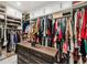 Spacious walk-in closet with custom shelving, drawers, and ample hanging space for clothes and accessories at 601 Suffolk Cir, Nokomis, FL 34275