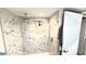 Modern bathroom featuring a marble tiled shower, rainfall shower head, and built-in shelving at 6400 46Th N Ave # 113, Kenneth City, FL 33709