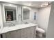 Bright bathroom features double vanity with marble countertop and modern light fixtures at 6400 46Th N Ave # 113, Kenneth City, FL 33709