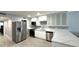 Modern kitchen features white cabinets, marble countertops, and stainless steel appliances at 6400 46Th N Ave # 113, Kenneth City, FL 33709