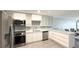 Updated kitchen with stainless steel appliances, tiled backsplash, and granite countertops at 6400 46Th N Ave # 113, Kenneth City, FL 33709
