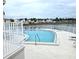 Inviting community pool overlooking a scenic lake and the surrounding community at 6400 46Th N Ave # 113, Kenneth City, FL 33709