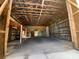 Interior view of a large barn with wooden beams and ample open space, ideal for storage or workshop at 6923 13Th E Ave, Bradenton, FL 34208