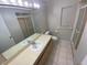 Bright bathroom featuring a large mirror, vanity with sink, and a shower with sliding glass door at 6923 13Th E Ave, Bradenton, FL 34208