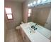 Bright bathroom featuring a large mirror, vanity with sink, and a shower with bathtub at 6923 13Th E Ave, Bradenton, FL 34208
