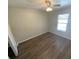 Well-lit bedroom features a ceiling fan, hardwood floors, and a window providing natural light at 6923 13Th E Ave, Bradenton, FL 34208