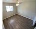 Bright bedroom featuring a ceiling fan, hardwood floors, and a window providing natural light at 6923 13Th E Ave, Bradenton, FL 34208