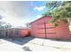 Exterior view of home with a large pink barn and plenty of parking space and yard at 6923 13Th E Ave, Bradenton, FL 34208