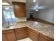 Open-concept kitchen and living area with a fireplace and lots of natural light at 6923 13Th E Ave, Bradenton, FL 34208