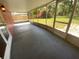 Enclosed patio featuring a concrete floor, screened windows with a serene backyard view at 6923 13Th E Ave, Bradenton, FL 34208