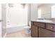 Clean bathroom featuring a shower-tub combo with white tile and granite vanity at 7113 Park Tree Dr, Tampa, FL 33625