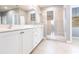 Bright bathroom with white vanity, granite countertop and glass-enclosed shower, complemented by tiled floor at 7113 Park Tree Dr, Tampa, FL 33625