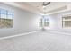 Spacious bedroom with large windows offering natural light and featuring a tray ceiling with fan at 7113 Park Tree Dr, Tampa, FL 33625