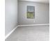 Carpeted room featuring neutral gray walls and bright window at 7113 Park Tree Dr, Tampa, FL 33625