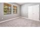 Neutral bedroom showcasing plush carpet, two bright windows with wood blinds, and a double-door closet at 7113 Park Tree Dr, Tampa, FL 33625