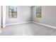 Light-filled bedroom with neutral gray walls, plush carpeting, and bright windows at 7113 Park Tree Dr, Tampa, FL 33625