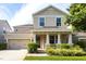 Charming two-story home featuring a covered front porch, well-maintained landscaping, and an attached two-car garage at 7113 Park Tree Dr, Tampa, FL 33625
