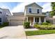 Beautiful two-story house showcasing a well-manicured lawn, two car garage, and inviting front porch at 7113 Park Tree Dr, Tampa, FL 33625