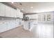 Bright kitchen featuring white cabinets, stainless steel appliances, island with sink, and tile flooring throughout at 7113 Park Tree Dr, Tampa, FL 33625