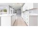 Open-concept kitchen boasts white cabinets, stainless steel appliances, an island, and seamless flow to the living area at 7113 Park Tree Dr, Tampa, FL 33625