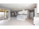 Modern kitchen with white cabinets, stainless steel appliances, island with sink, open to living room, and tile flooring at 7113 Park Tree Dr, Tampa, FL 33625