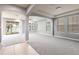 Open living room features recessed lighting, wall-to-wall carpet, plenty of windows, and access to a covered patio at 7113 Park Tree Dr, Tampa, FL 33625