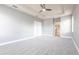 Open main bedroom boasts tray ceiling with fan and ensuite bath, plus a view to hall at 7113 Park Tree Dr, Tampa, FL 33625
