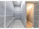 Walk-in pantry equipped with wire shelving, offering ample storage space, and tiled floor at 7113 Park Tree Dr, Tampa, FL 33625