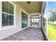 Covered patio with brick flooring overlooking lush backyard at 7113 Park Tree Dr, Tampa, FL 33625