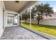 Screened in patio with brick flooring overlooking a well-maintained lawn at 7113 Park Tree Dr, Tampa, FL 33625