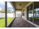 Covered patio with brick flooring and screened enclosure at 7113 Park Tree Dr, Tampa, FL 33625