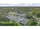 Aerial view of tennis courts at the University Park Country Club surrounded by lush greenery at 7507 Ascot Ct, University Park, FL 34201