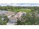 Lovely home featuring mature trees and landscaping next to a well manicured golf course at 7507 Ascot Ct, University Park, FL 34201