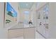 Pool bar with a light blue speckled countertop, white cabinets, and access to the pool area through french doors at 7507 Ascot Ct, University Park, FL 34201