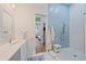 Bright bathroom featuring a tiled shower with a rainfall shower head, a white vanity, and a view of the bedroom at 7507 Ascot Ct, University Park, FL 34201
